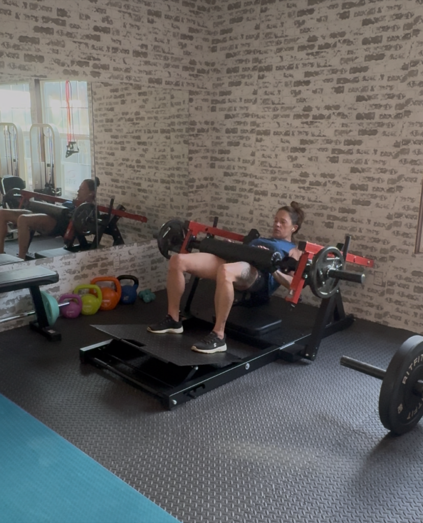 Woman using a hip thrust machine in a home gym